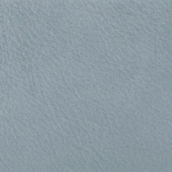 Textured gray rug with mottled surface, displaying dense irregular lines and ridges resembling distressed leather, studio lighting.